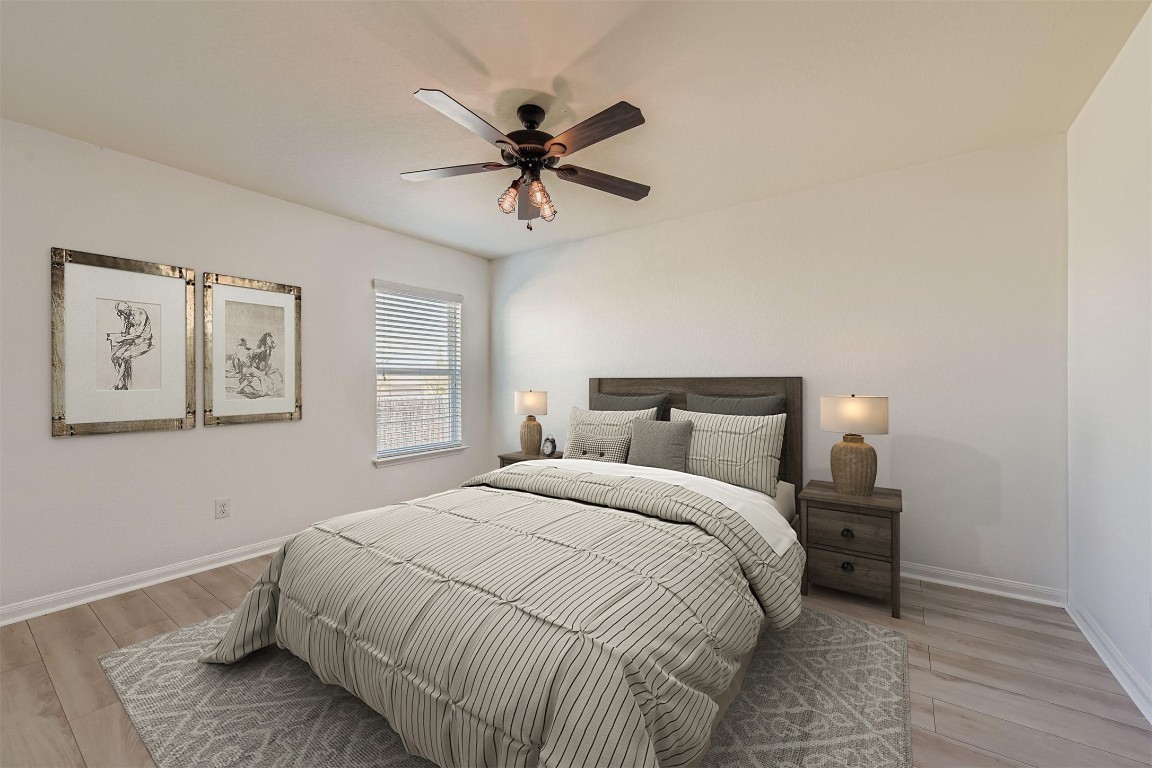 232 Millers Loop Jarrell, TX 76537 - Photo 15 of 34 a bedroom with a bed and a chandelier