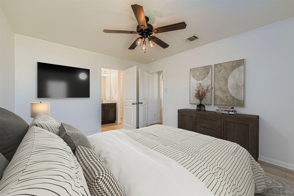 232 Millers Loop Jarrell, TX 76537 - Photo 21 of 34 a bedroom with a bed and a flat screen tv