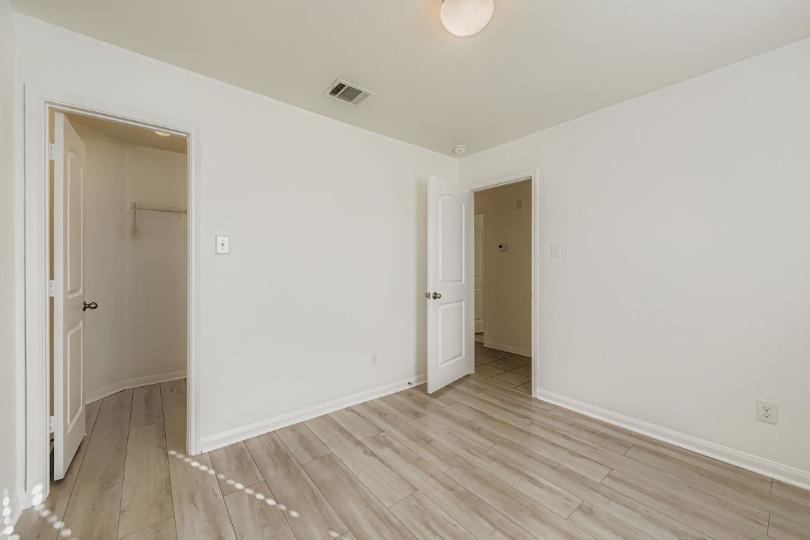 232 Millers Loop Jarrell, TX 76537 - Photo 24 of 34 a view of an empty room with wooden floor and closet