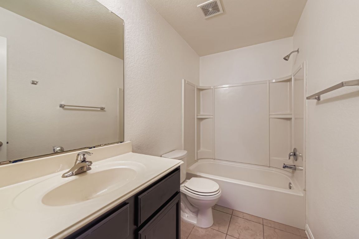 232 Millers Loop Jarrell, TX 76537 - Photo 25 of 34 a bathroom with a sink toilet and shower