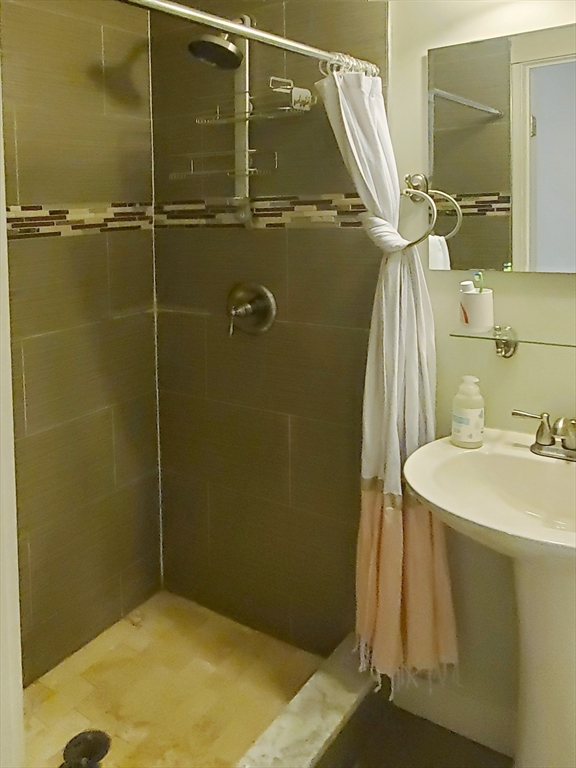 23 Ralph Piteri Terrace, Unit 3 Watertown, MA 02472 - Photo 7 of 7 a bathroom with a sink and mirror