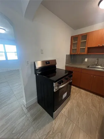 a kitchen with stainless steel appliances granite countertop a stove and a sink