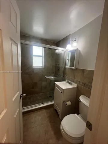 a bathroom with a toilet sink and shower