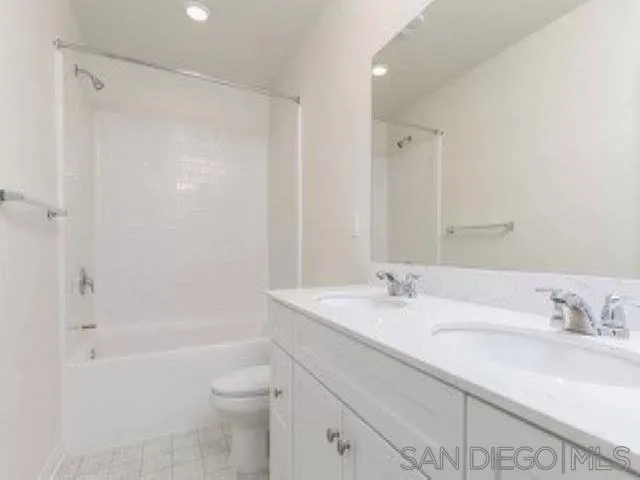 365 Fitzpatrick Road, Unit 102 San Marcos, CA 92069 - Photo 11 of 11 a bathroom with a granite countertop sink a toilet and shower