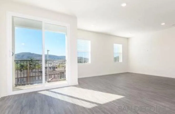 365 Fitzpatrick Road, Unit 102 San Marcos, CA 92069 - Photo 2 of 11 an empty room with windows and entrance