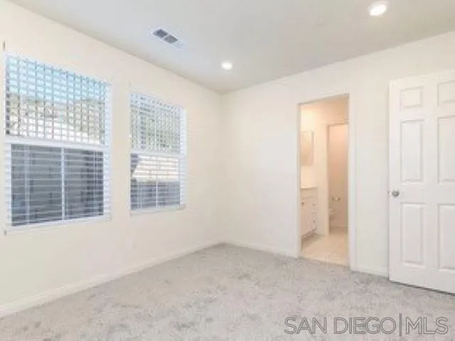 365 Fitzpatrick Road, Unit 102 San Marcos, CA 92069 - Photo 7 of 11 a view of an empty room with a window