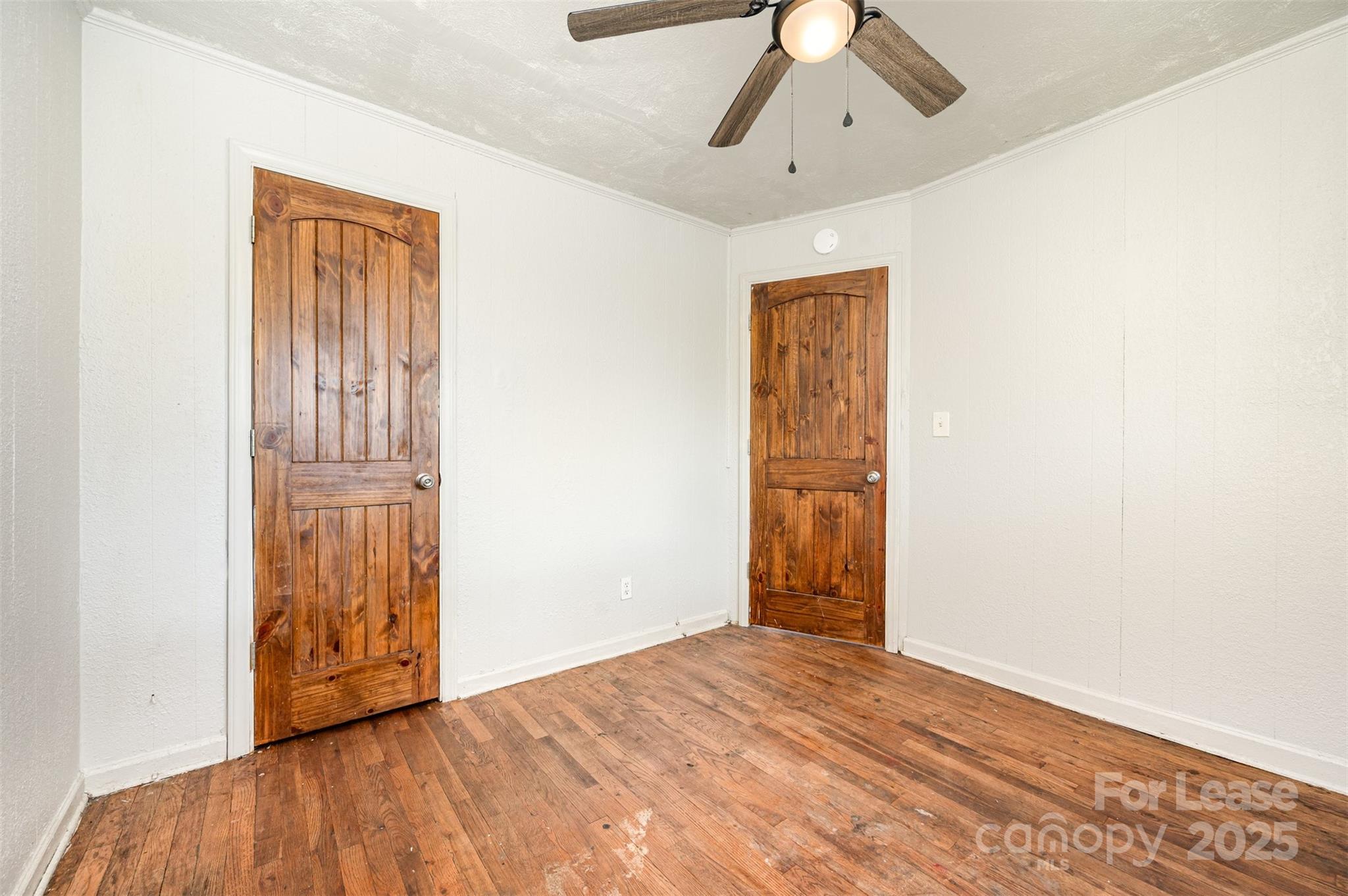 2407 Julia Avenue, Unit 3 Charlotte, NC 28206 - Photo 12 of 13 a view of an empty room with wooden floor and a ceiling fan