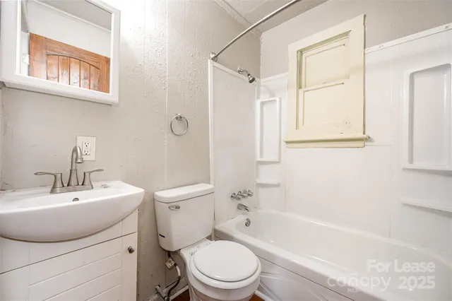 a bathroom with a toilet a sink and a bathtub
