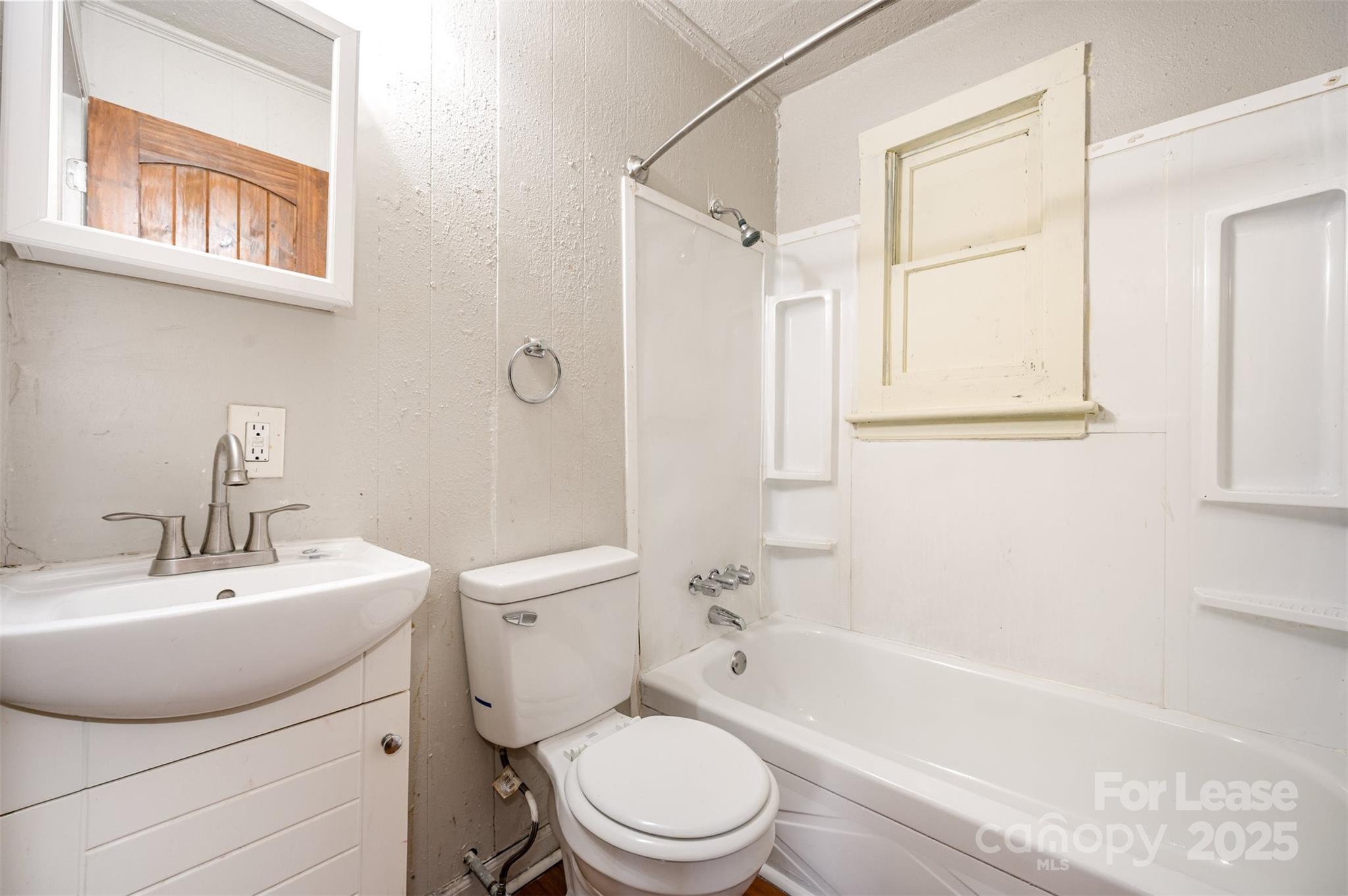2407 Julia Avenue, Unit 3 Charlotte, NC 28206 - Photo 13 of 13 a bathroom with a toilet a sink and a bathtub