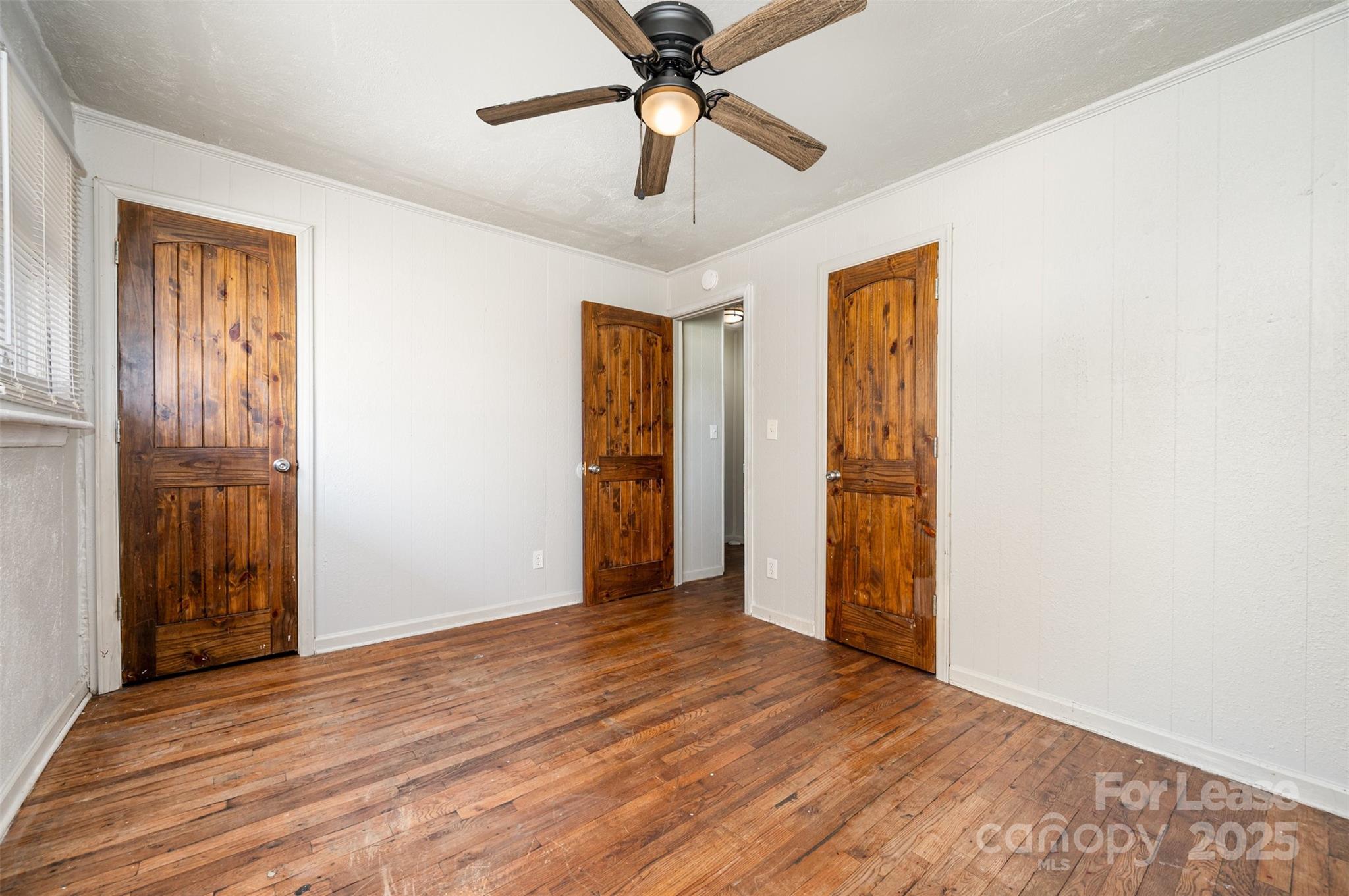 2407 Julia Avenue, Unit 3 Charlotte, NC 28206 - Photo 10 of 13 a view of an empty room with window and wooden floor