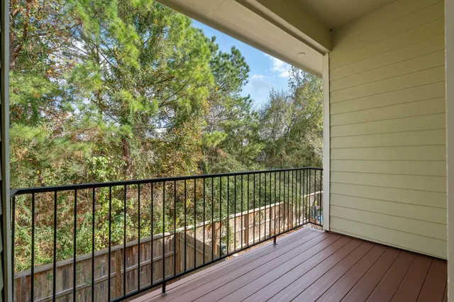 a view of balcony with wooden floor