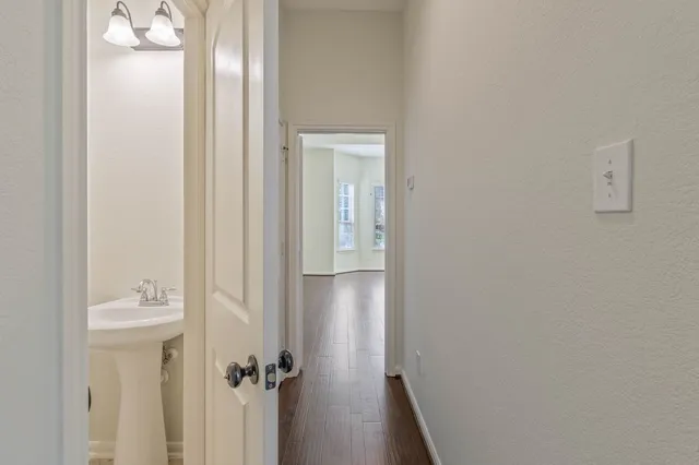 a view of an empty room with wooden floor