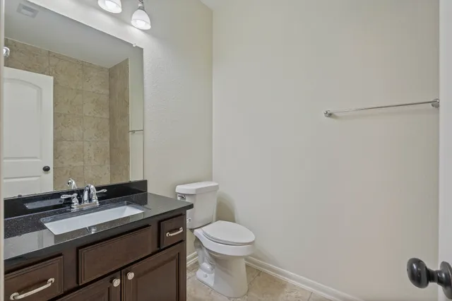a white toilet sitting next to a bath tub