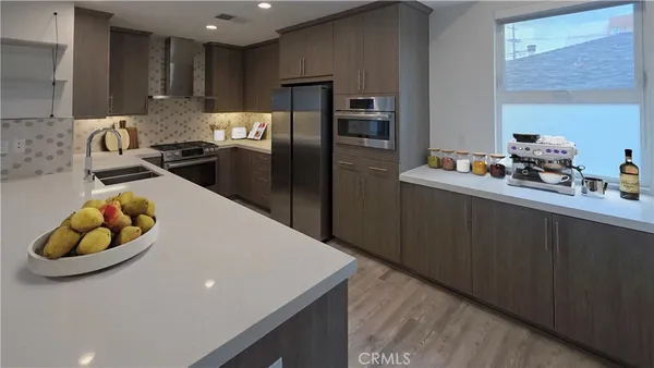 a kitchen with cabinets and steel stainless steel appliances