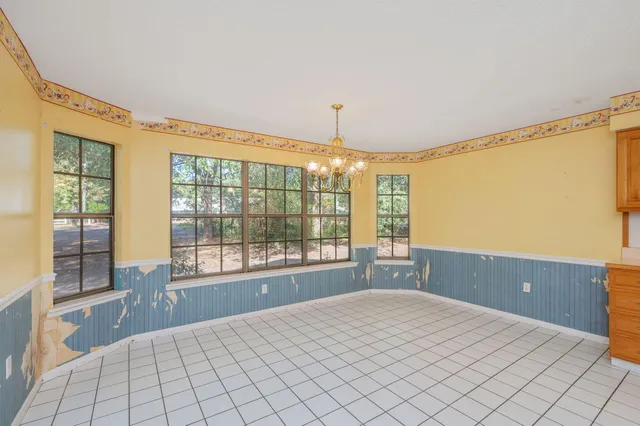 a spacious bedroom with a large bed and a large window