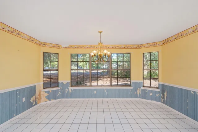 a spacious bedroom with a large bed and a large window