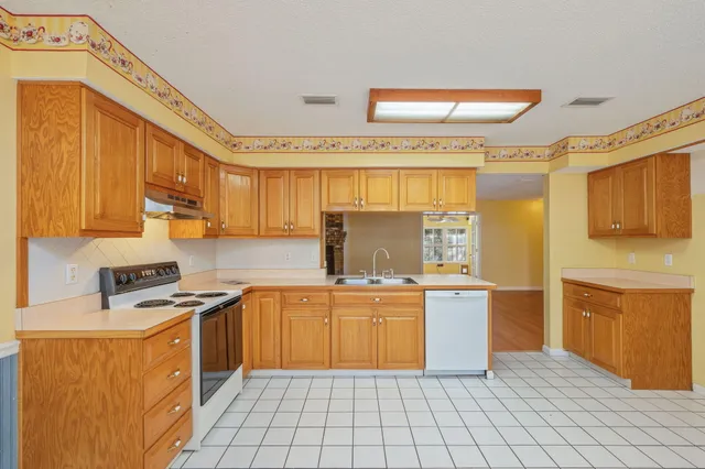 a kitchen with stainless steel appliances a stove sink and cabinets