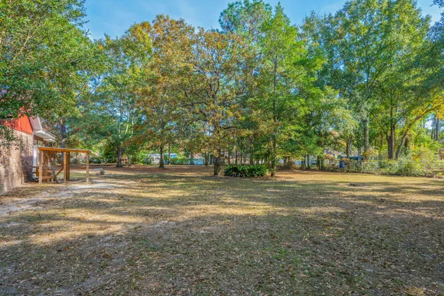 a view of a field with trees in the background