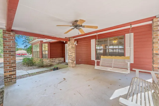 a view of a room with wooden floor and windows