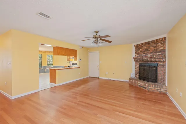 a view of a kitchen with a sink and a fireplace