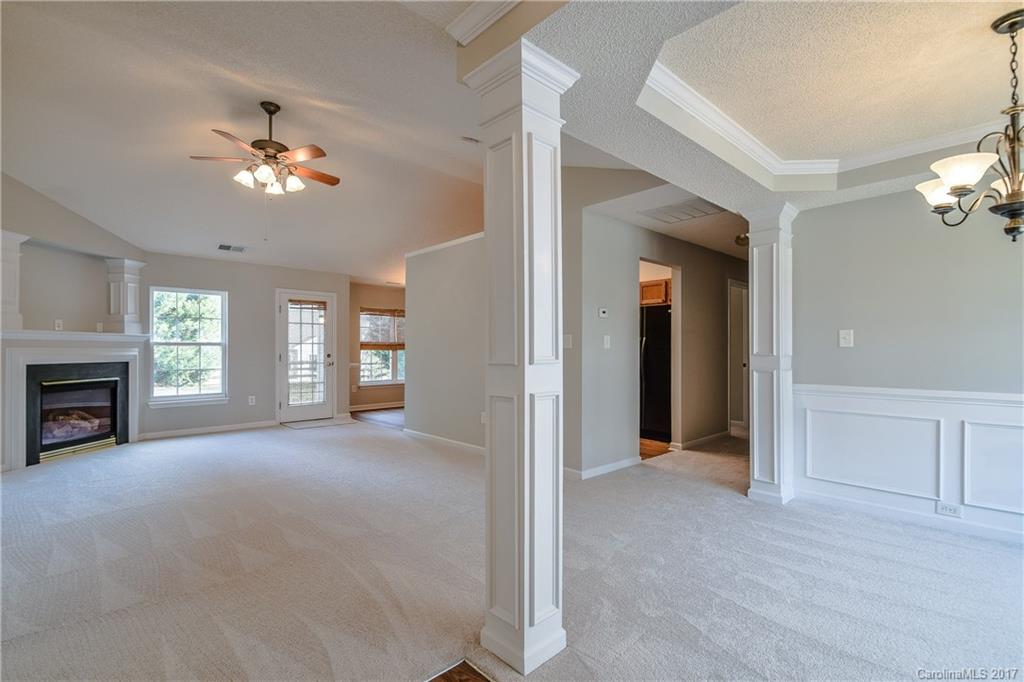 13422 Latta Gordon Road Huntersville, NC 28078 - Photo 4 of 24 a view of empty room with a fireplace and fan