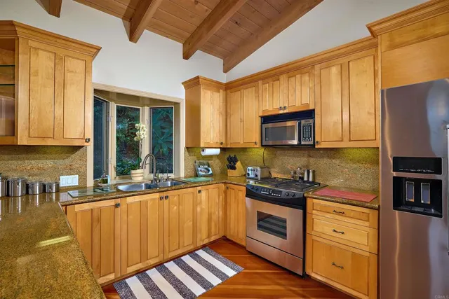a kitchen with wooden cabinets and a sink