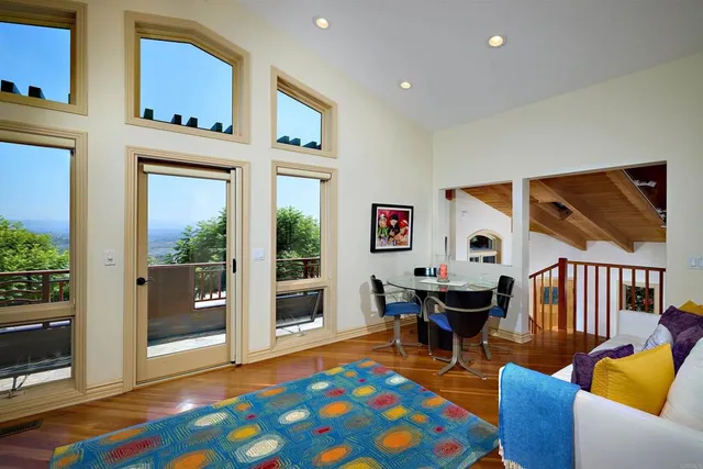 a living room with furniture and paintings on the wall