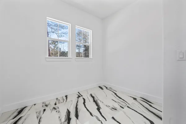 a bedroom with a bed and glass window