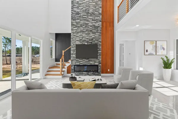 a living room with fireplace furniture and a large window