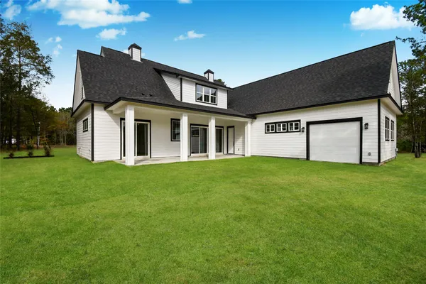 a view of a house with a yard and garage