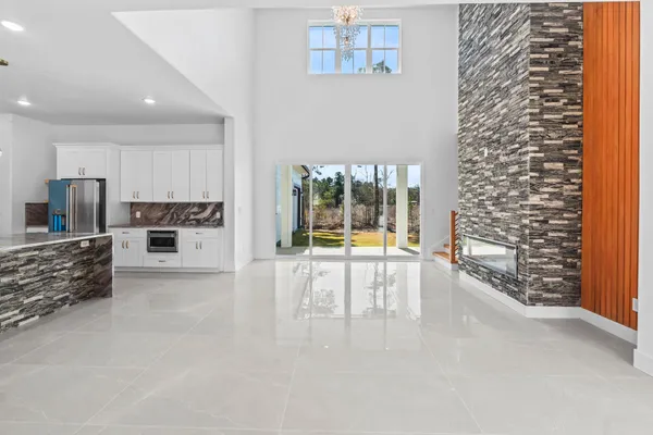 a view of open kitchen with a sink and cabinets