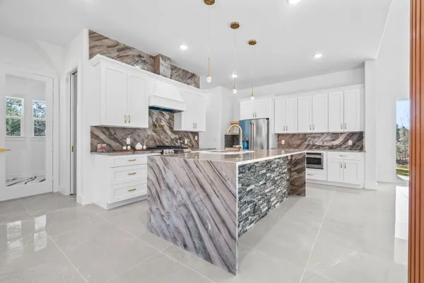a kitchen with counter top space cabinets and stainless steel appliances