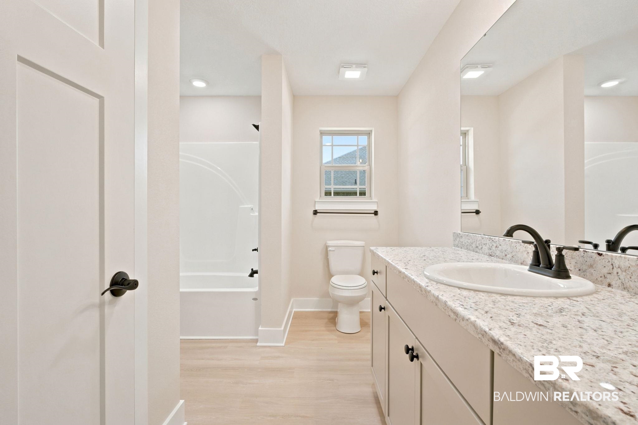 32656 Arbor Ridge Circle Lillian, AL 36549 - Photo 24 of 56 Bathroom featuring a dual-sink vanity with a speckled countertop, undermount sinks, and matte black fixtures