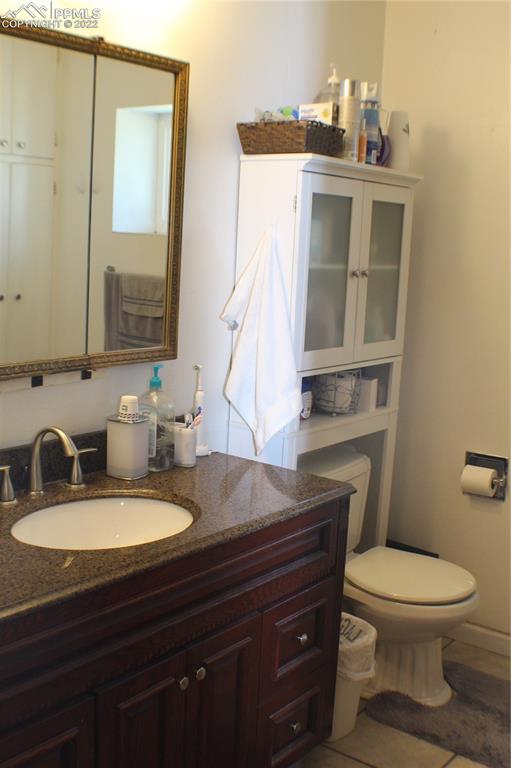 29454 County Farm Road Pueblo, CO 81006 - Photo 11 of 25 a bathroom with a toilet a sink and mirror
