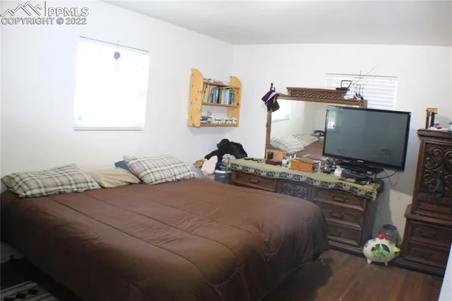 a bedroom with a bed and dresser