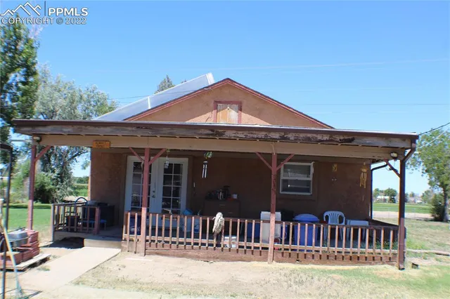 a view of a big room with a big yard and large trees