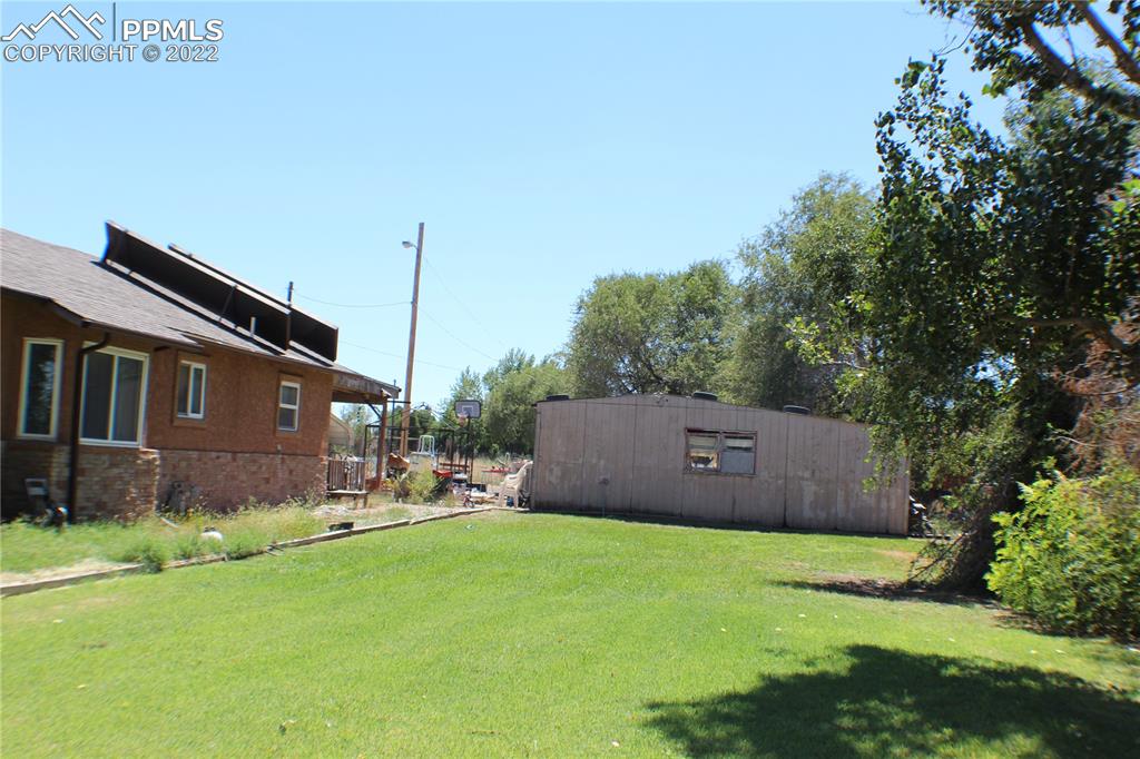 29454 County Farm Road Pueblo, CO 81006 - Photo 19 of 25 a view of a big room with a big yard and large trees