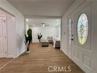 a view of living room filled with furniture and a chandelier