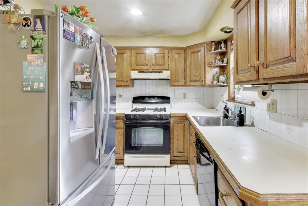 3 River St Court Lynn, MA 01905 - Photo 7 of 24 a kitchen with stainless steel appliances a stove a refrigerator and a sink