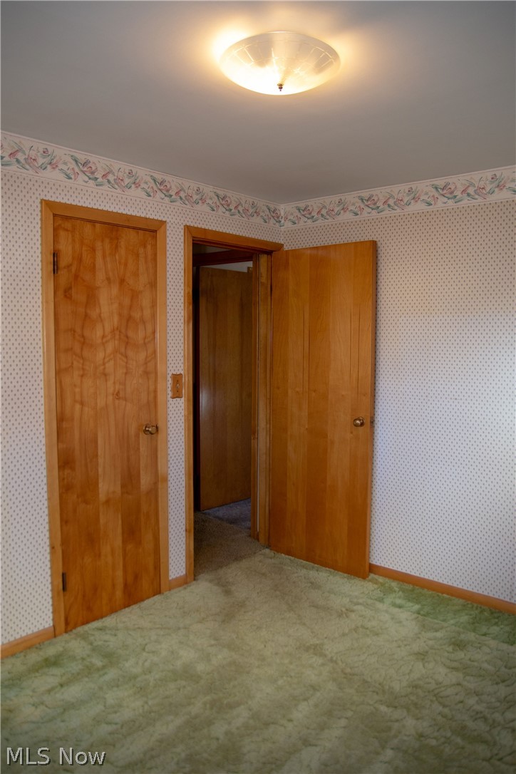 926 Ridge Road Northwest Canton, OH 44703 - Photo 11 of 35 2nd view of bedroom, nice woodwork, replacement windows, single closet with hardwood floor (seller believes there is no hardwood under carpet)