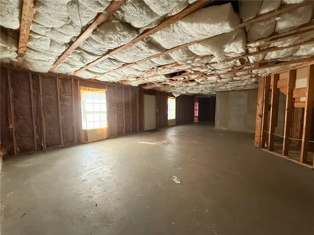 a view of a room with a wooden roof and a window