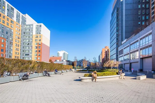 a view of a building with sitting area and swimming pool