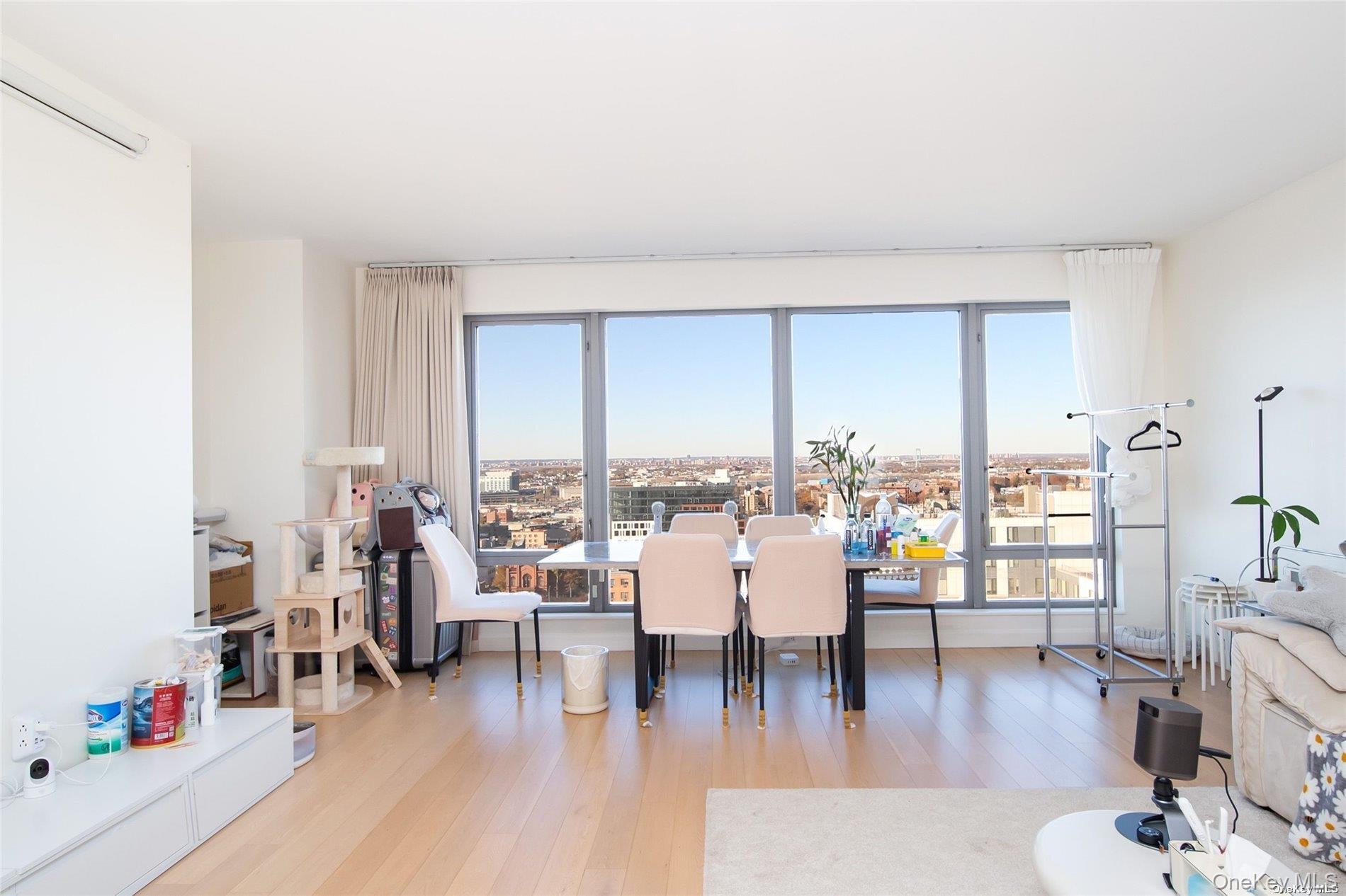 138-35 39th Avenue, Unit 16K Queens, NY 11354 - Photo 10 of 21 a living room with furniture and a wooden floor