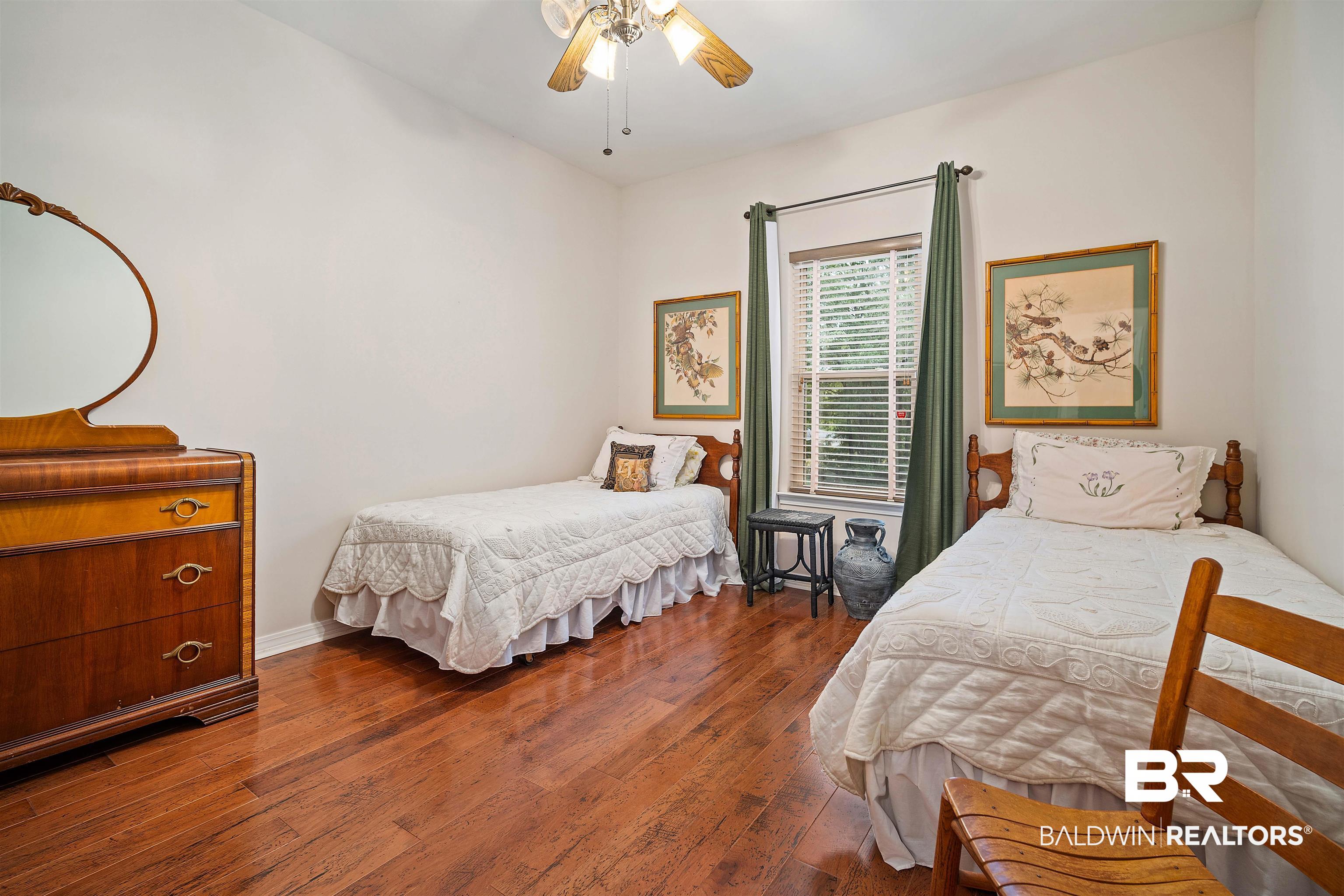 7419 Pake Road Saraland, AL 36571 - Photo 20 of 27 Bedroom with ceiling fan and dark wood-type flooring