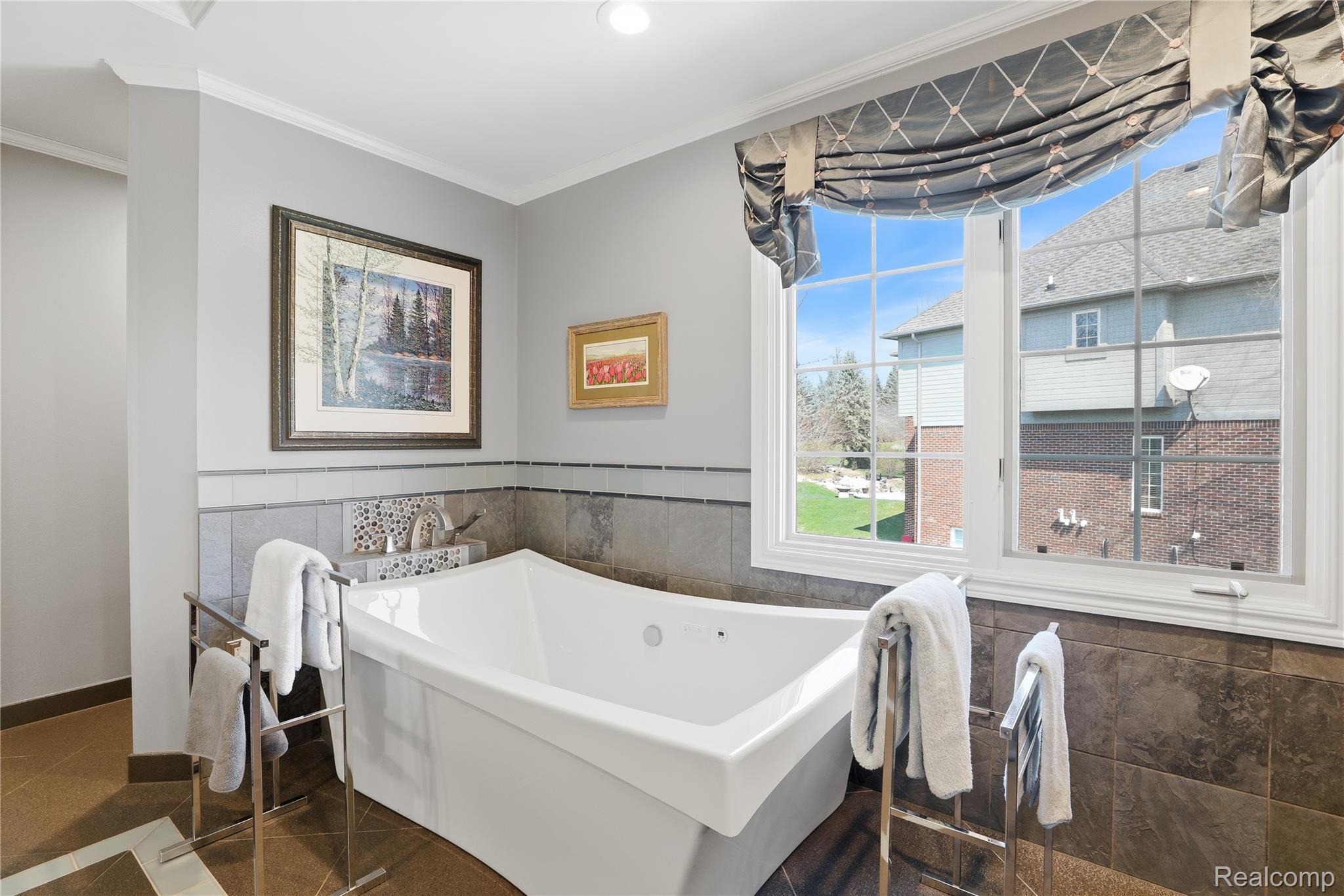668 Springview Drive Rochester, MI 48307 - Photo 46 of 90 Full bathroom featuring tile walls, a freestanding bath, wainscoting, and crown molding