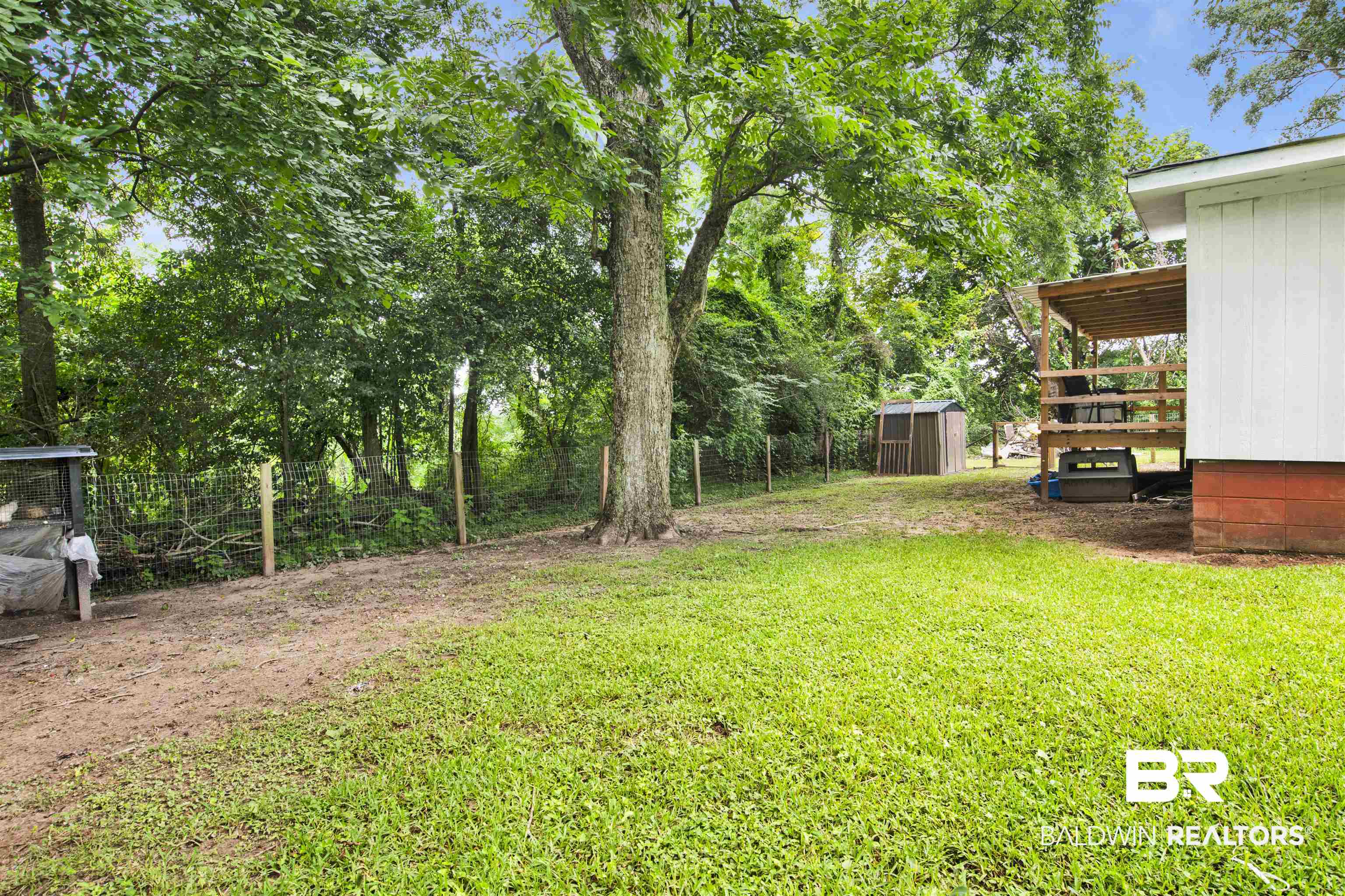 4265 Greaves Road Eight Mile, AL 36613 - Photo 29 of 34 View of yard featuring a storage unit and a deck
