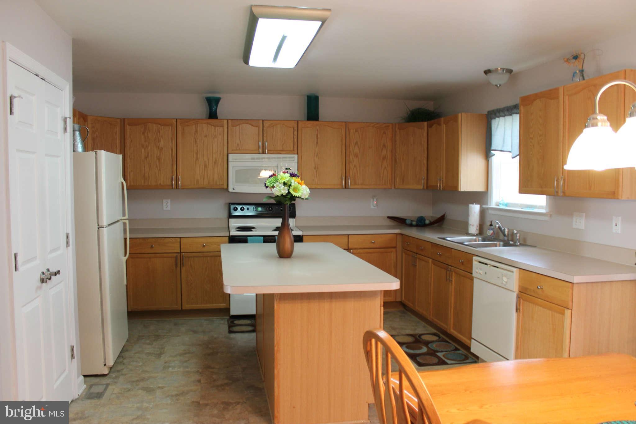 107 Estate Lane Ranson, WV 25438 - Photo 11 of 30 a kitchen with a refrigerator and a sink