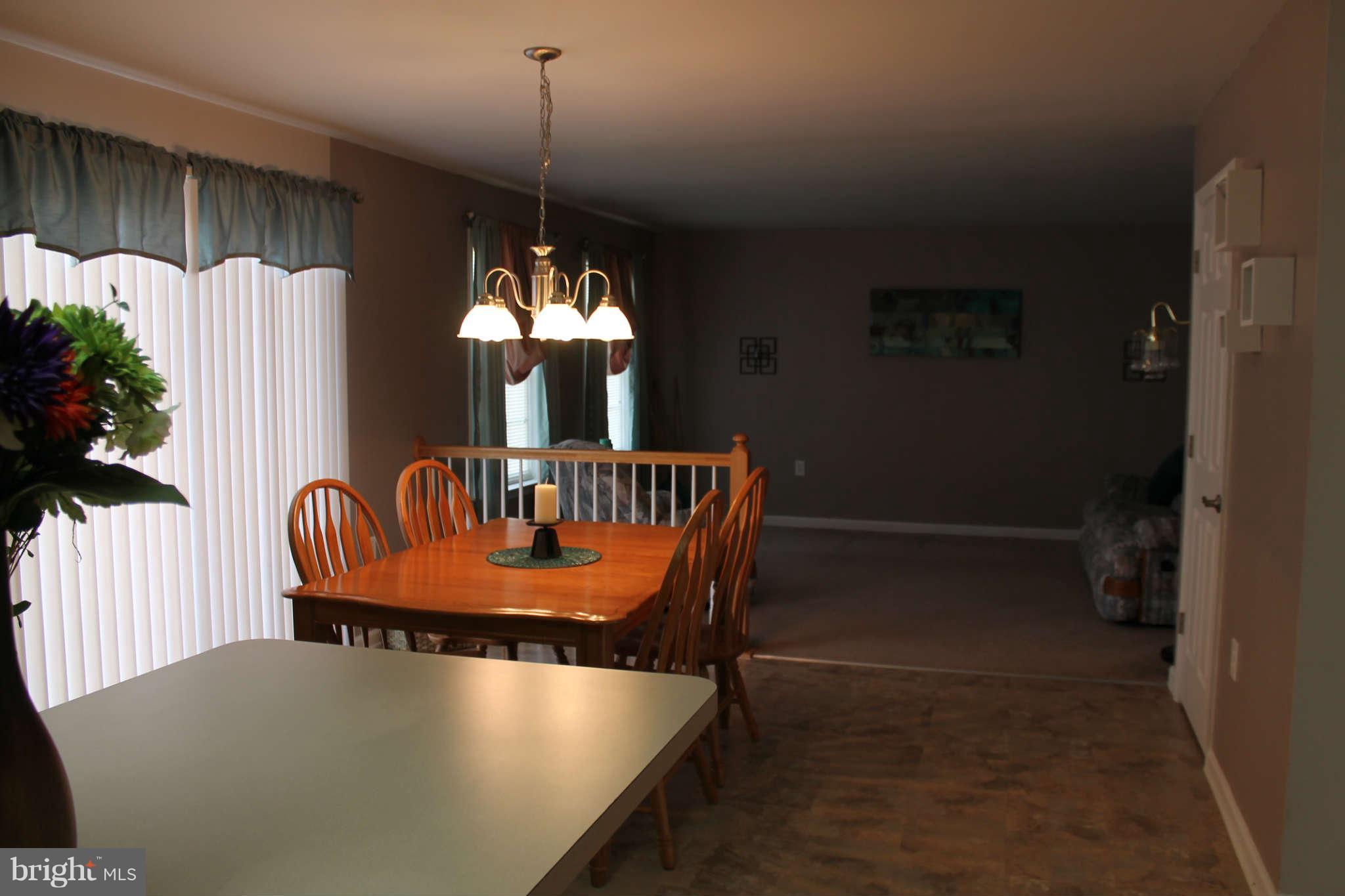 107 Estate Lane Ranson, WV 25438 - Photo 13 of 30 a dining room with furniture a chandelier and window