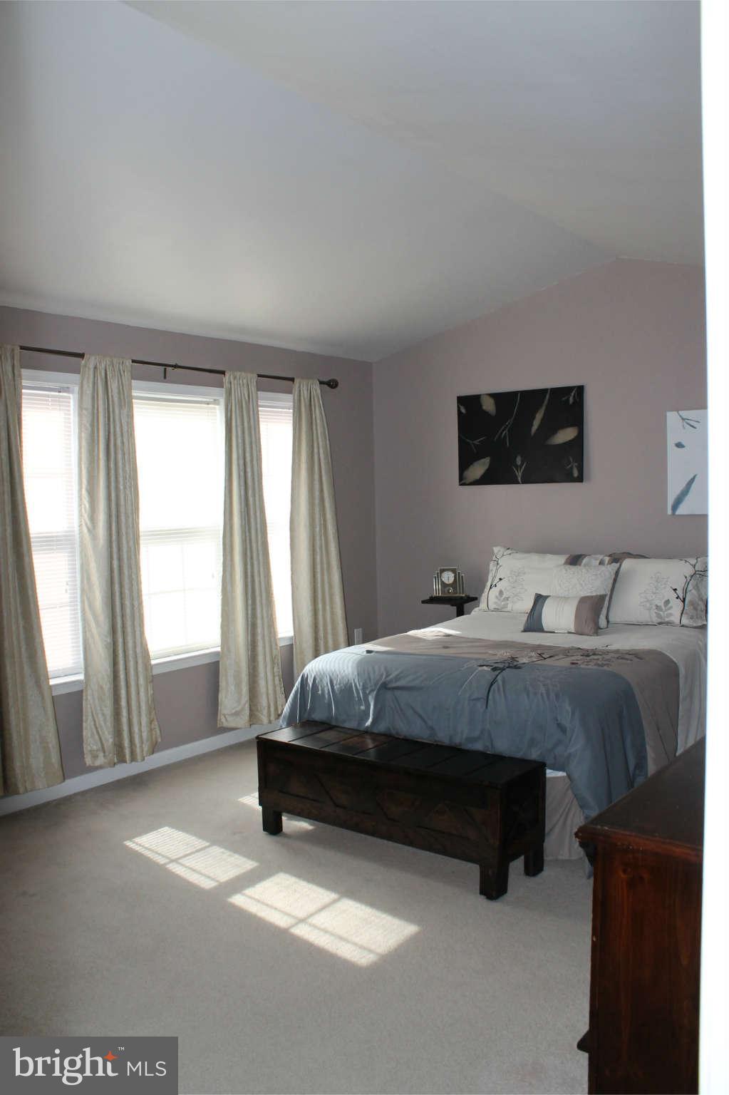 107 Estate Lane Ranson, WV 25438 - Photo 16 of 30 a spacious bedroom with a bed and window