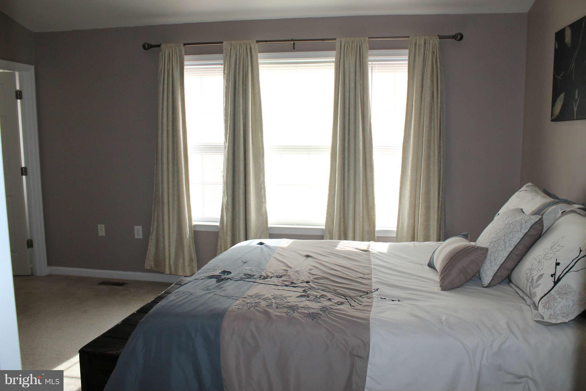 107 Estate Lane Ranson, WV 25438 - Photo 17 of 30 a bedroom with a bed and a window